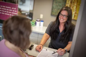 Staff member going over paperwork with a patient