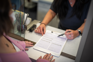 Staff member going over paperwork with a patient